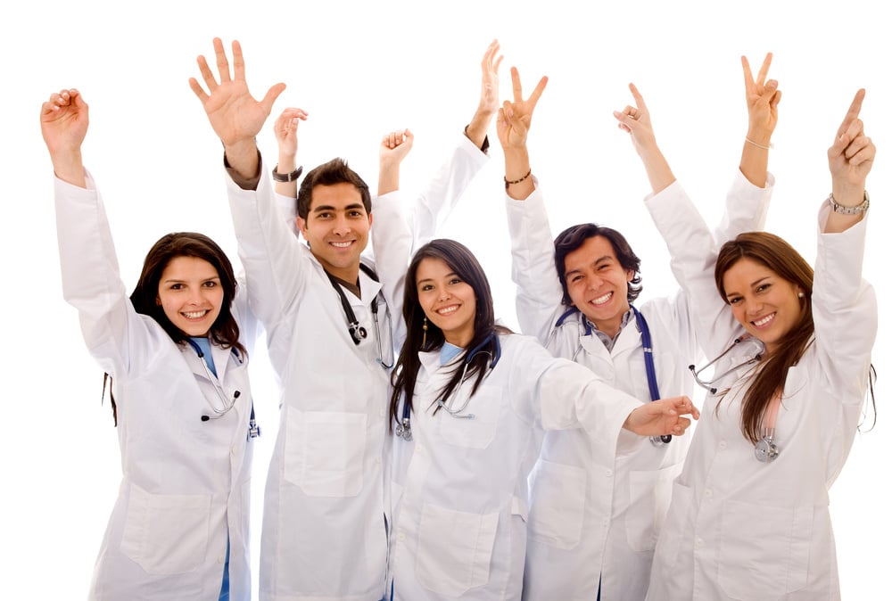 Very happy group of doctors isolated over a white background Very happy group of doctors isolated over a white background